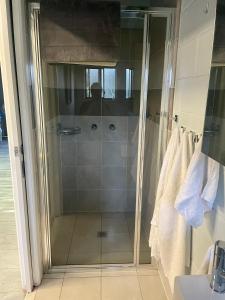 a shower with a glass door in a bathroom at The Marlin House Iluka in Iluka +28 photos