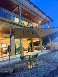 a table and chairs in front of a building at Pure Sand Lanta Resort in Ko Lanta +26 photos