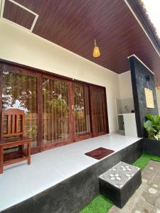 a living room with a bench and windows at Pondok tulamben in Karangasem +4 photos