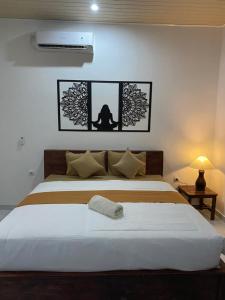 a bedroom with a large white bed in a room at Pondok tulamben in Karangasem