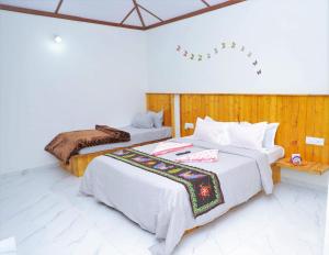 En eller flere senge i et værelse på Vantara Agro Resort & Farm Stay