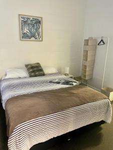 a bedroom with a large bed in a room at The Marlin House Iluka in Iluka
