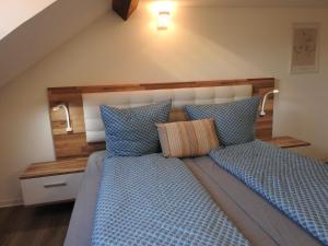 a bedroom with a bed with blue pillows at Ferienwohnungen am Hauptplatz in Pirna