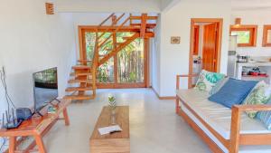 a living room with a couch and a ladder at Vila Budião - Corumbau in Corumbau