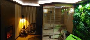a living room with a fish tank and a chair at GreenHouse pool & spa in Otruševec +40 photos