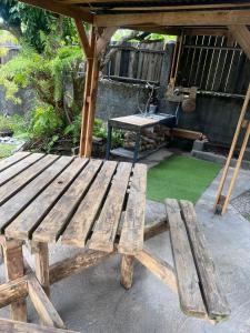 a wooden bench sitting in front of a table at Fleur de Canne in Saint-Benoît