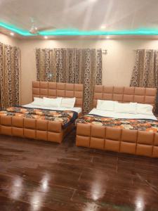 two beds in a room with two mattresses at Hotel taimoor in Srinagar