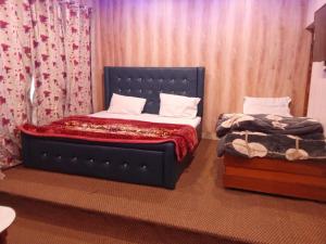 a bedroom with a blue bed and a bedskirts at Hotel taimoor in Srinagar