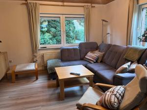 a living room with a couch and a table at Hümmlische Auszeit RE15 in Sögel +11 photos