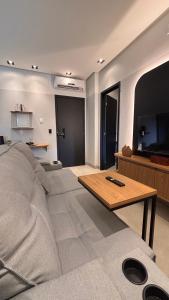 a living room with a couch and a table at Smart Residence Moderno in Santarém
