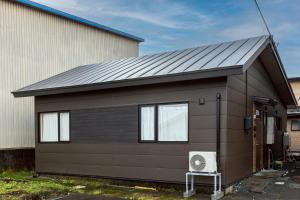 a house with a solar roof on top of it at Pine21 TOHOKU 
