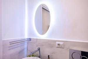 ein Badezimmer mit Spiegel und Waschbecken in der Unterkunft Ginevra Luxury Taormina in Taormina