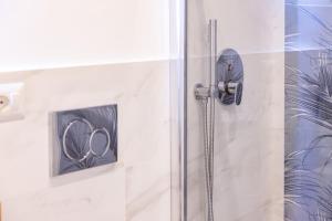 eine Dusche mit einer Glastür mit einer Duschspule in der Unterkunft Ginevra Luxury Taormina in Taormina