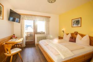 a bedroom with a large bed and a window at Bio Bauernhof Holzegghof in Zell am See in Erlberg