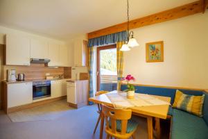 a kitchen and dining room with a table and chairs at Bio Bauernhof Holzegghof in Zell am See in Erlberg