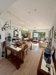 a living room with a table and a dining room at The White House in Calafell