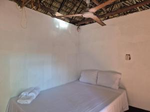 En eller flere senge i et værelse på Hostal El Paredon