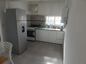 a kitchen with a refrigerator and a sink at San Cayetano in Paraná
