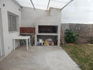 a patio with a table and a fireplace in a building at San Cayetano in Paraná