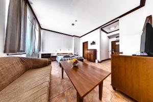een woonkamer met een bank en een tafel bij Спа Хотел Орфей in Devin