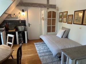 a room with a bed and a table in it at LE PARC DU VIVIER in Fernestrelay