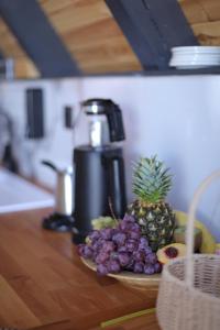 a plate of fruit on a table with a coffee maker at Beloris Bungalov in Erenköy