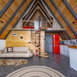 a living room with a couch and a red refrigerator at Beloris Bungalov in Erenköy