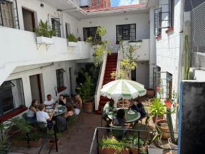 a group of people sitting at tables outside a building at Long Street Backpackers in Cape Town