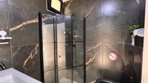 a shower with a glass door in a bathroom at פרמיום בכינרת in Tiberias +36 photos