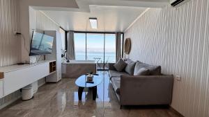 a living room with a couch and a television at פרמיום בכינרת in Tiberias