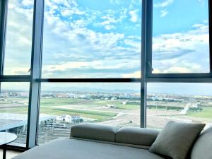 a couch sitting in front of a large window at Panoramic Sea Suites II By VALENCIAFLATS EU in Valencia