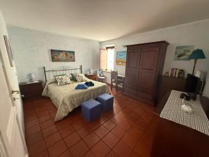 ein Schlafzimmer mit einem Bett und einem Tisch und einem Fernseher in der Unterkunft Centro Storico in Anagni