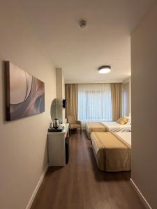 a hotel room with two beds and a television at Fatih Resadiye Hotel in Istanbul +47 photos
