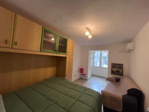 a bedroom with a green bed and a chair at Al Castello 2 in Bari