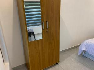 a wooden door in a room with a window at Elysian in Mananthavady