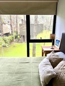 a bedroom with a bed and a large window at Jardines del Bosque in Costa del Este
