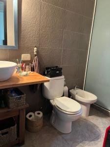 a bathroom with a toilet and a sink at Jardines del Bosque in Costa del Este