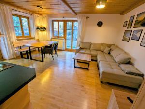 a living room with a couch and a table at Geigerhof Bad Heilbrunn in Bad Heilbrunn