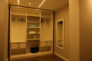 a walk in closet with white cabinets and a mirror at Munir`s residence 2 in Cairo +290 photos