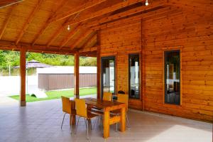 a wooden house with a wooden table and chairs at Moonking Chalet in Langkawi Islands