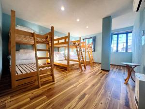 two bunk beds in a room with wooden floors at 富士Base御殿場 Station-Side Hideout in Gotemba +59 photos