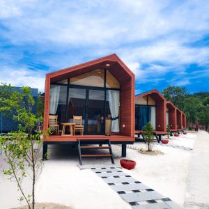 a small house with glass windows and a bench at Royal C Resort in Koh Rong Island