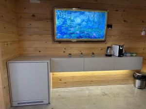 a counter in a room with a painting on the wall at Suncatcher Djurdjevic Apartmani in Banja Luka