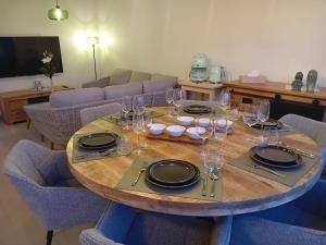 a table with plates and glasses on top of it at Hof van Sassenbroek in Borgloon