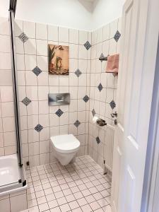 a bathroom with a toilet and a sink at Unser Märchenhaus in Braunlage +64 photos