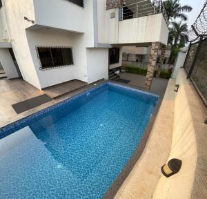 a swimming pool in front of a house at Aarna Villa nr Valvan Dam in Lonavala