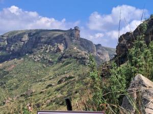 a view of a mountain with trees and rocks at Mount Everest Guest Farm in Harrismith