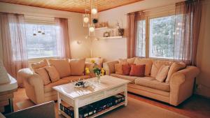 a living room with a couch and a table at Peaceful house for relaxing in Oulu