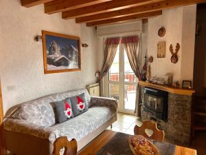 a living room with a couch and a fireplace at Casavacanza in Aprica