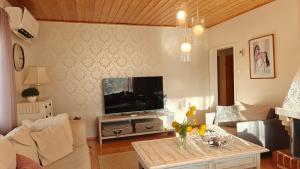 a living room with a television and a table at Peaceful house for relaxing in Oulu